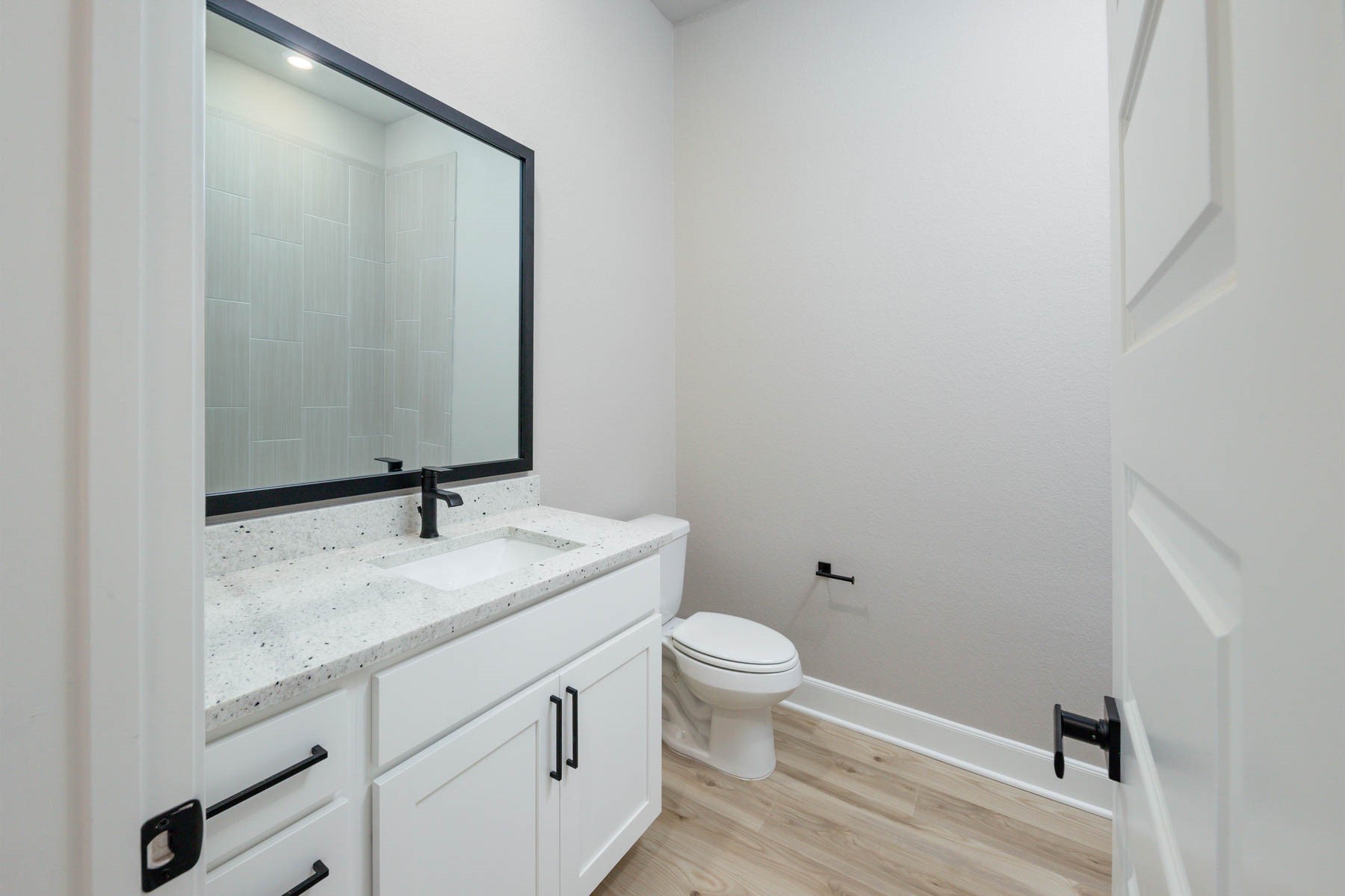 1907 June Lk Lane Iowa Colony, TX 77583 - Photo 7 of 11 a bathroom with a granite countertop sink toilet and mirror