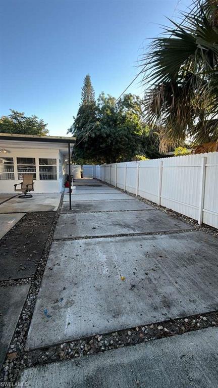 4439 23rd Place Southwest Naples, FL 34116 - Photo 11 of 15 Fenced backyard with a patio area and concrete driveway