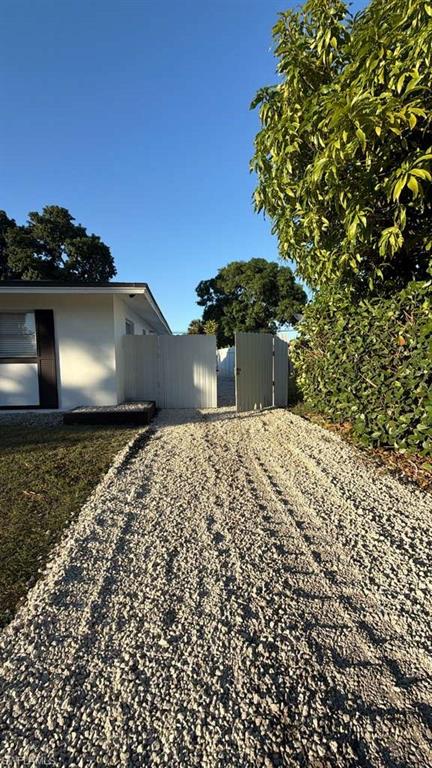 4439 23rd Place Southwest Naples, FL 34116 - Photo 15 of 15 View of home's exterior featuring a gate
