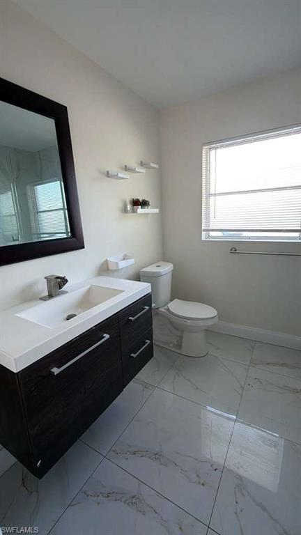 4439 23rd Place Southwest Naples, FL 34116 - Photo 2 of 15 Bathroom featuring vanity and light marble finish flooring
