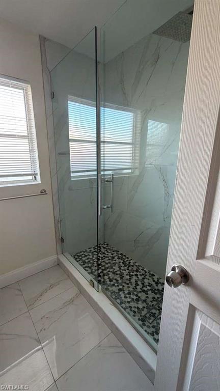 4439 23rd Place Southwest Naples, FL 34116 - Photo 3 of 15 Bathroom with light marble finish flooring and a marble finish shower