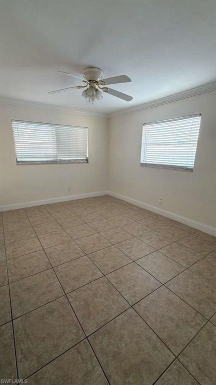 4439 23rd Place Southwest Naples, FL 34116 - Photo 4 of 15 Empty room featuring crown molding, ceiling fan, and light tile patterned floors