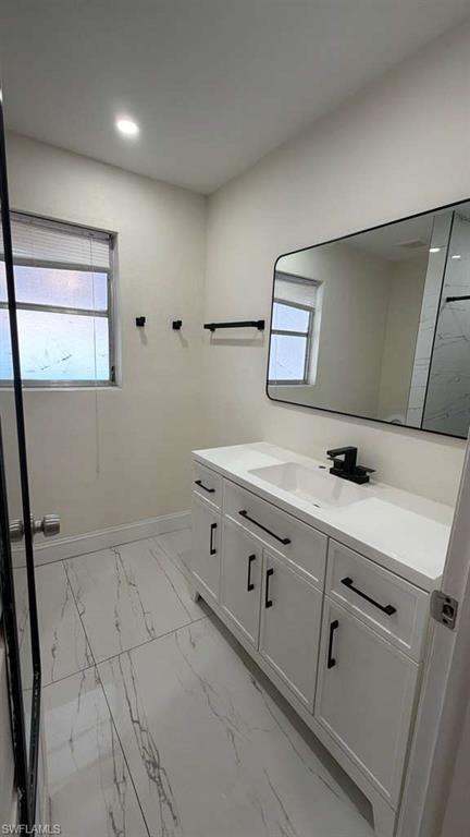 4439 23rd Place Southwest Naples, FL 34116 - Photo 5 of 15 Bathroom featuring light marble finish flooring, vanity, and recessed lighting