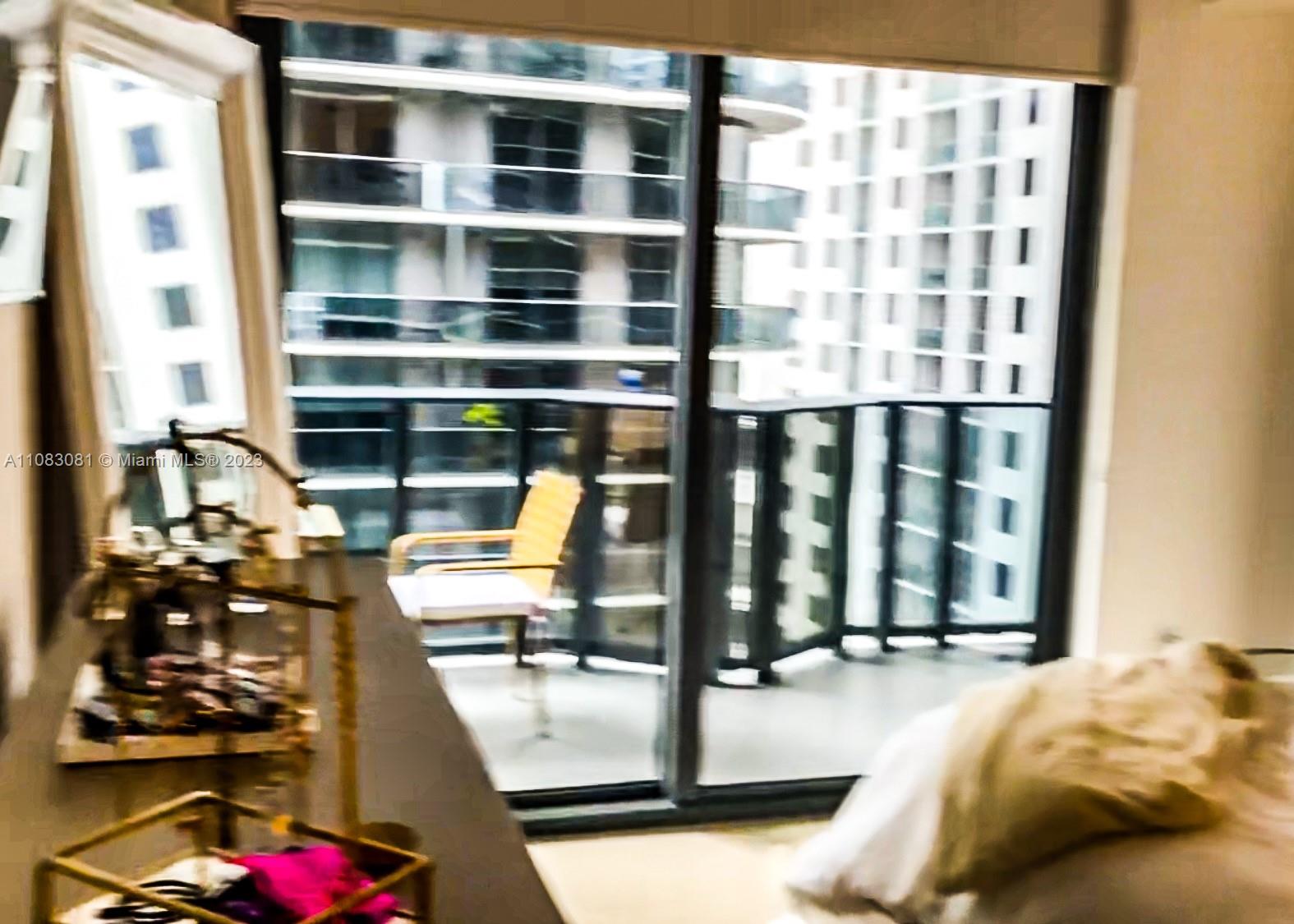 45 Southwest 9th Street, Unit 2207 Miami, FL 33130 - Photo 11 of 31 a view of walk in closet with clothes and shoes