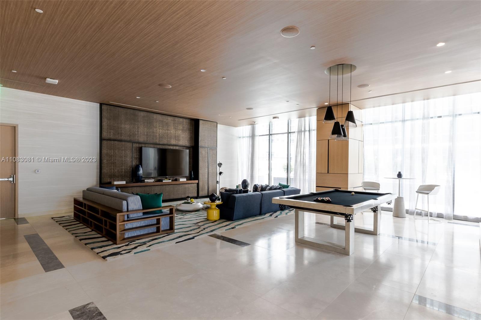 45 Southwest 9th Street, Unit 2207 Miami, FL 33130 - Photo 27 of 31 a living room with furniture and a flat screen tv