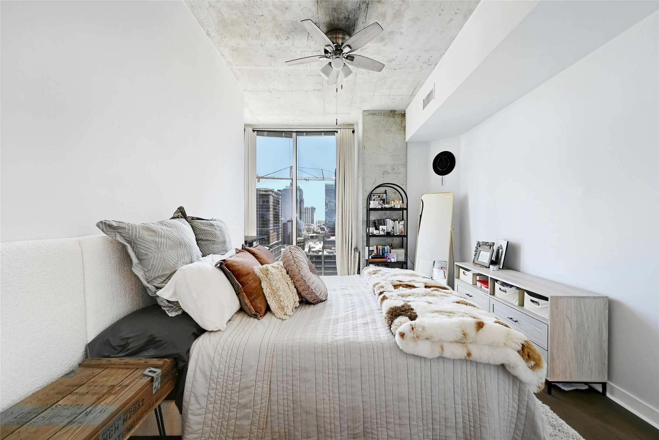 360 Nueces Street, Unit 1809 Austin, TX 78701 - Photo 12 of 25 Bedroom featuring a ceiling fan, a city view, and dark wood-style flooring