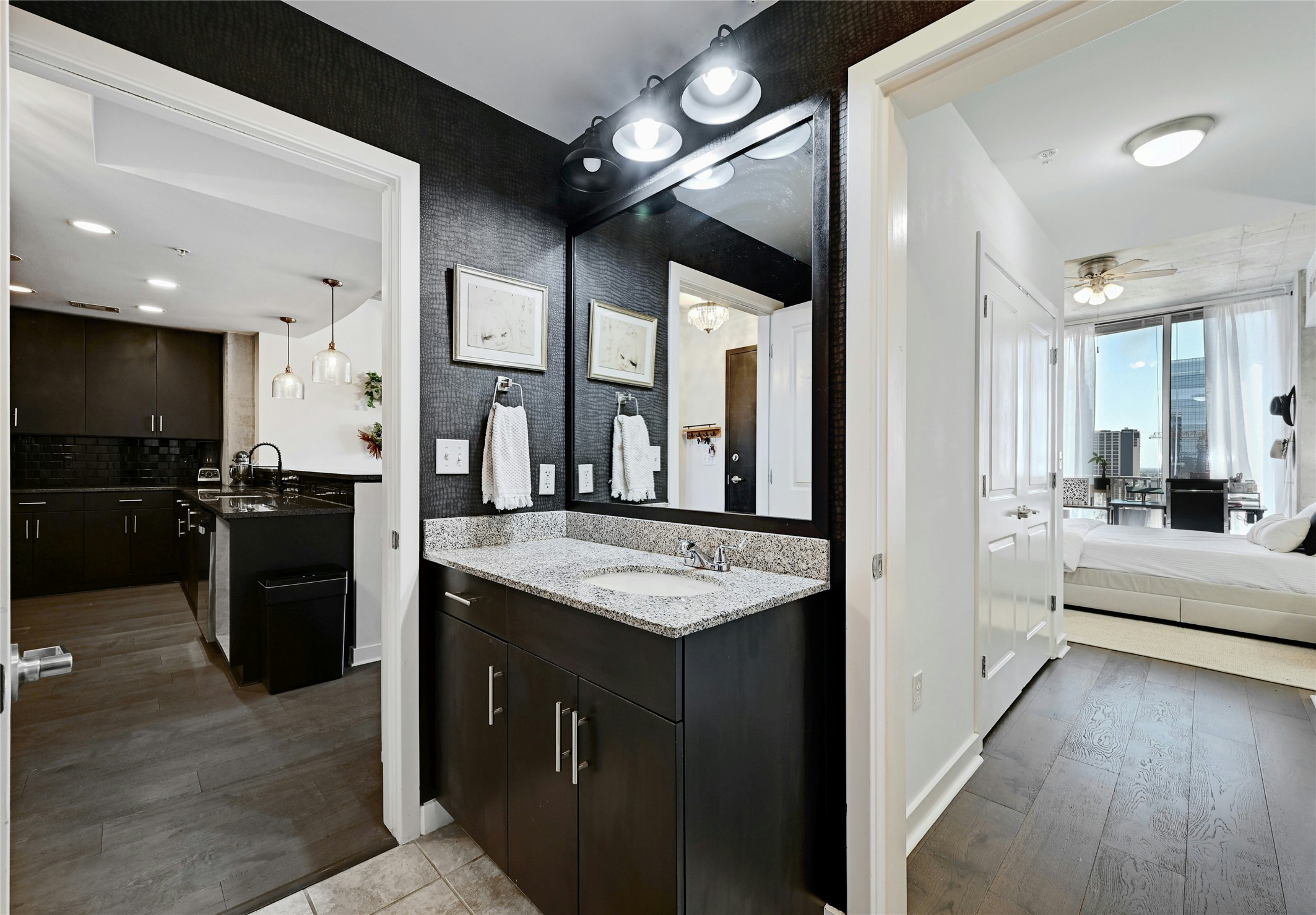360 Nueces Street, Unit 1809 Austin, TX 78701 - Photo 20 of 25 Ensuite bathroom featuring light wood-type flooring, vanity, ceiling fan, and tasteful backsplash