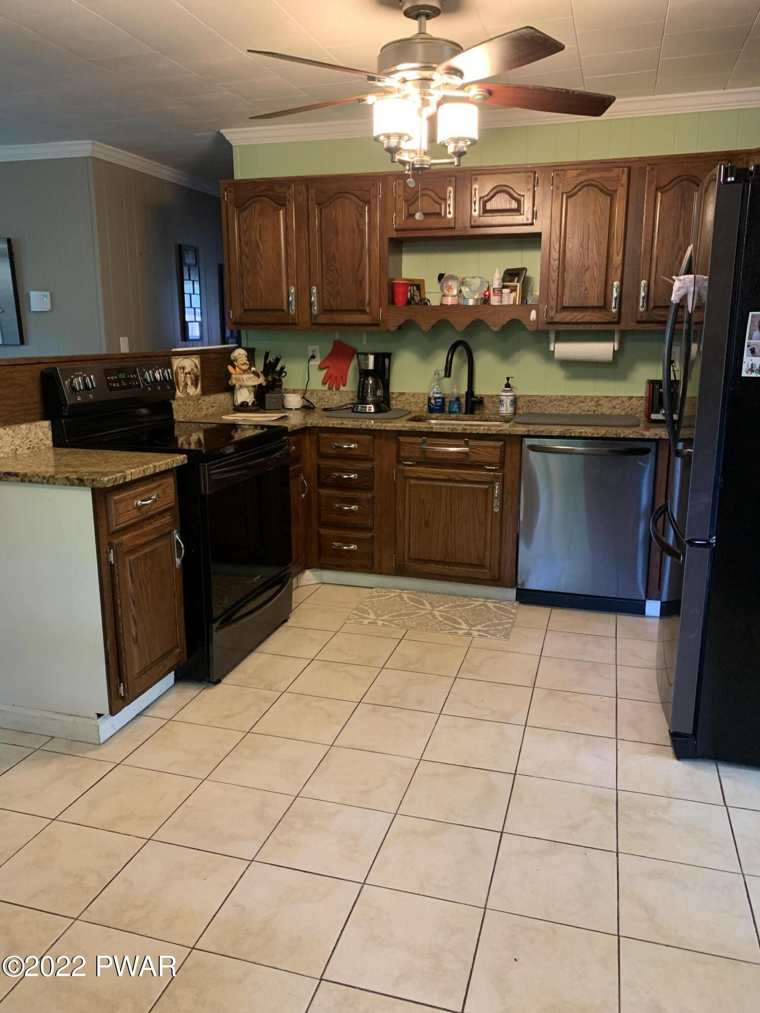 116 Red Pine Road Dingmans Ferry, PA 18328 - Photo 8 of 23 a kitchen with stainless steel appliances granite countertop a sink and cabinets