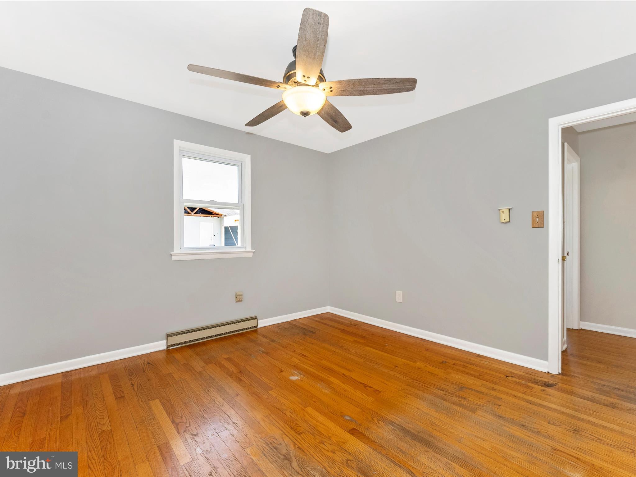 2833 Roderick Road Frederick, MD 21704 - Photo 19 of 41 an empty room with wooden floor fan and windows