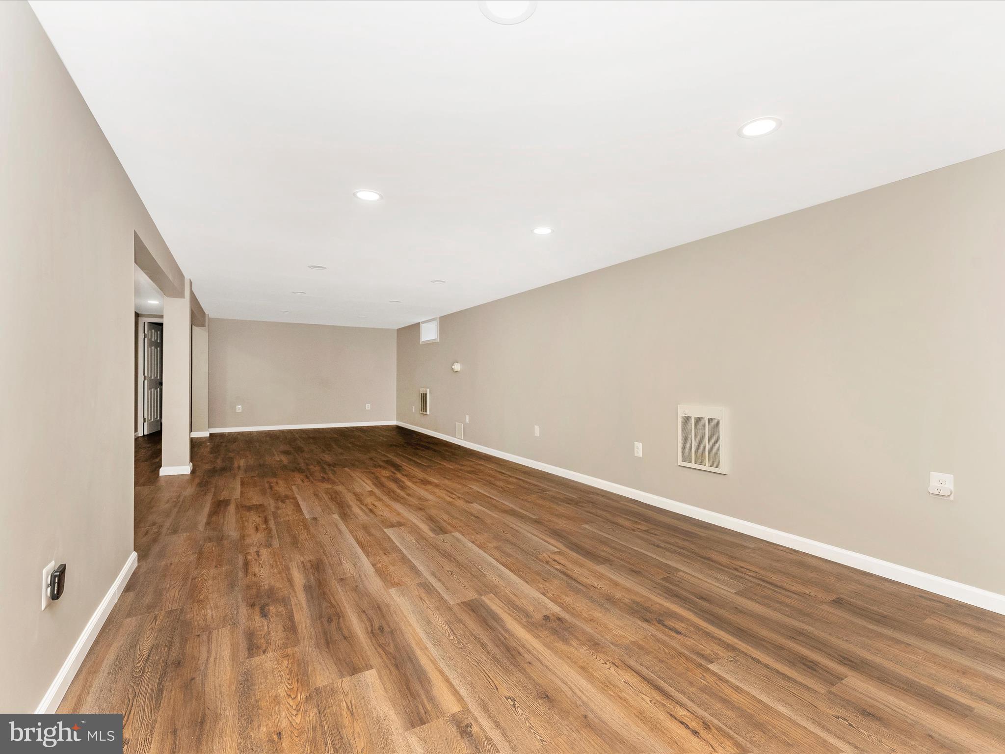 2833 Roderick Road Frederick, MD 21704 - Photo 27 of 41 a view of an empty room with wooden floor and a window