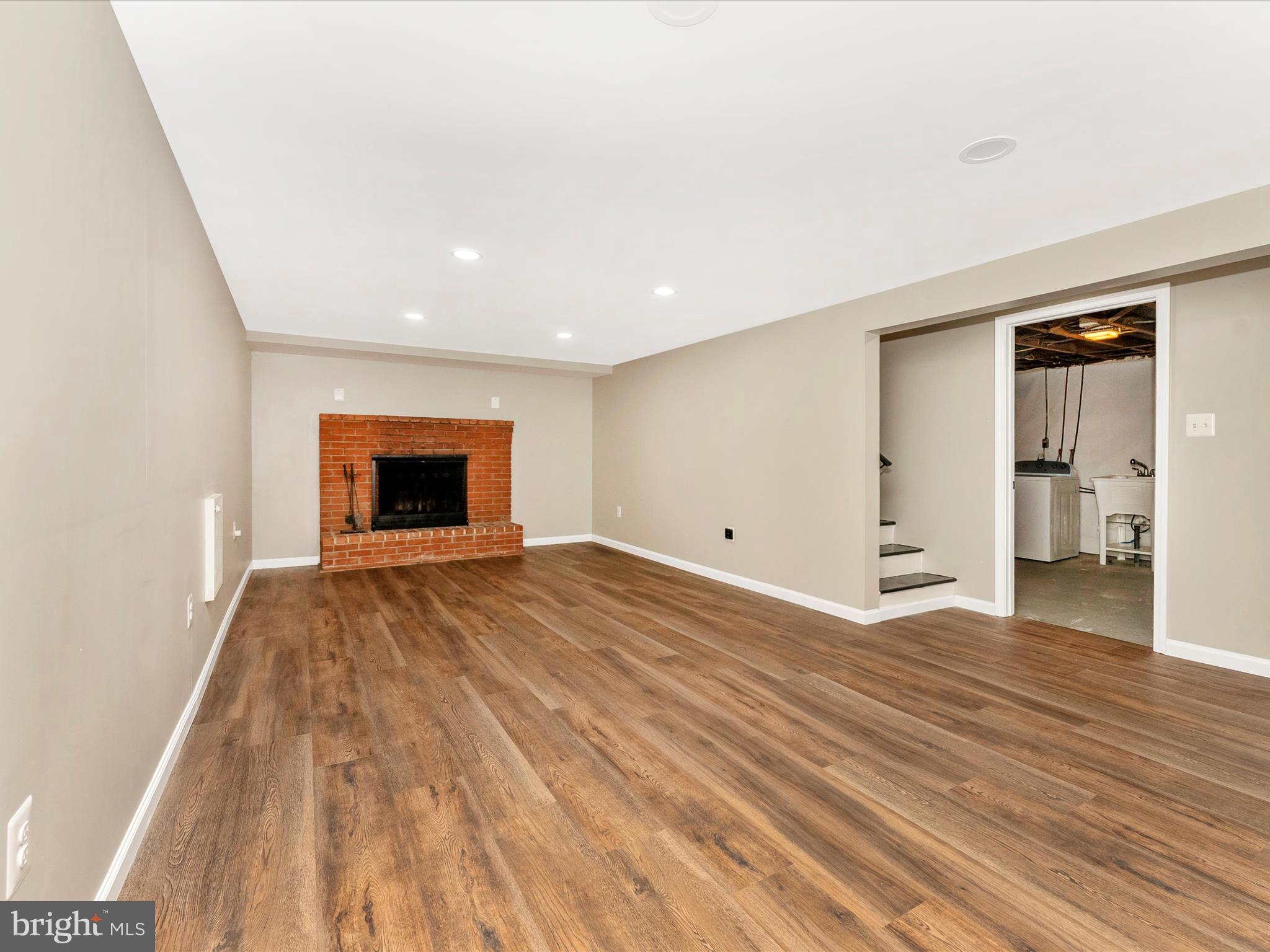 2833 Roderick Road Frederick, MD 21704 - Photo 28 of 41 a view of empty room with wooden floor and fireplace