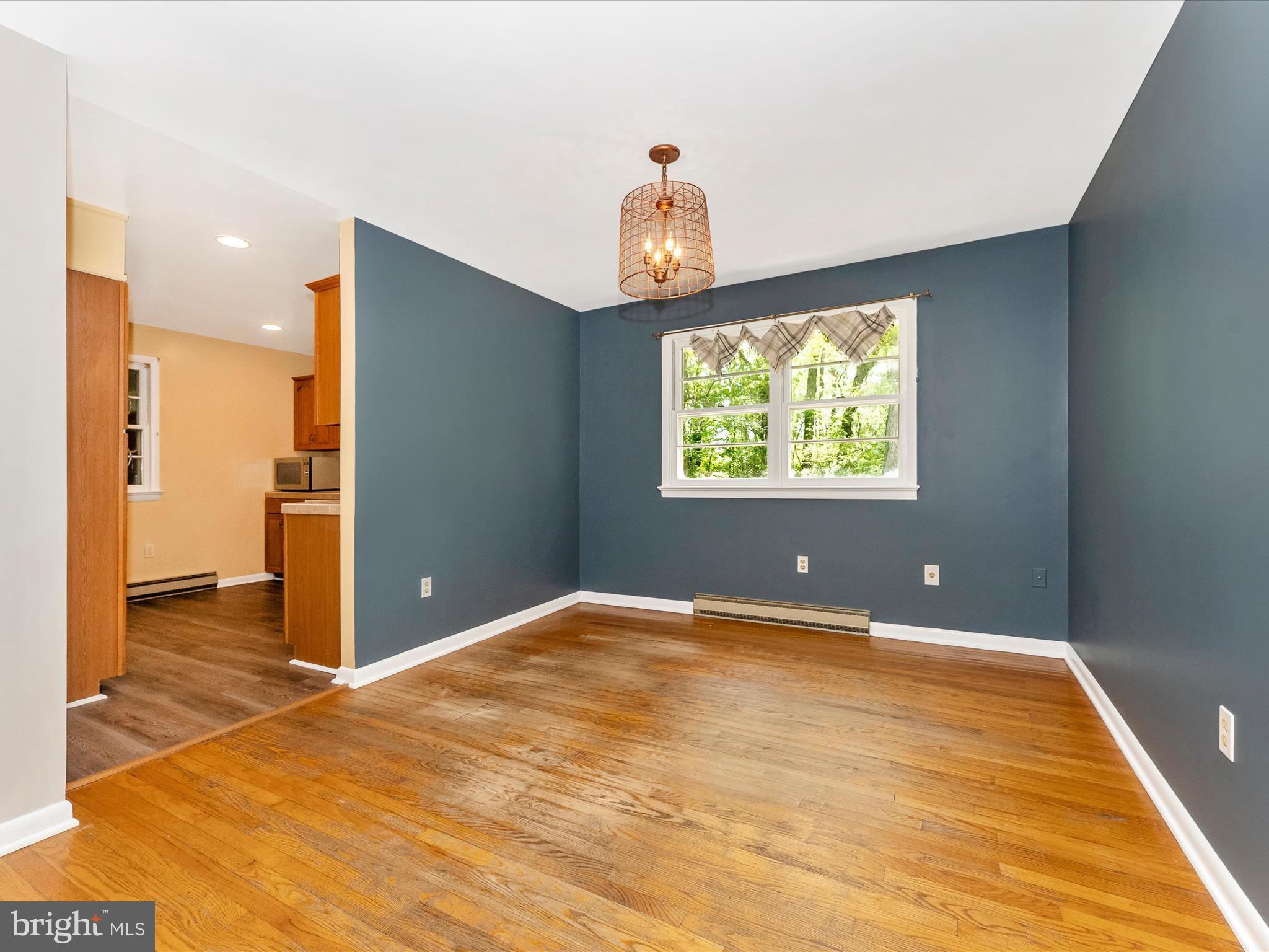 2833 Roderick Road Frederick, MD 21704 - Photo 8 of 41 a view of an empty room with wooden floor and a window