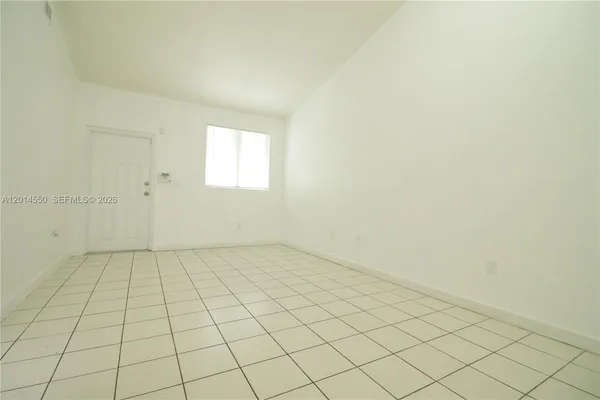 an empty room with white walls