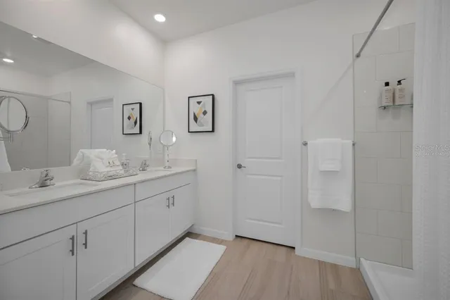 a bathroom with a double vanity sink and mirror