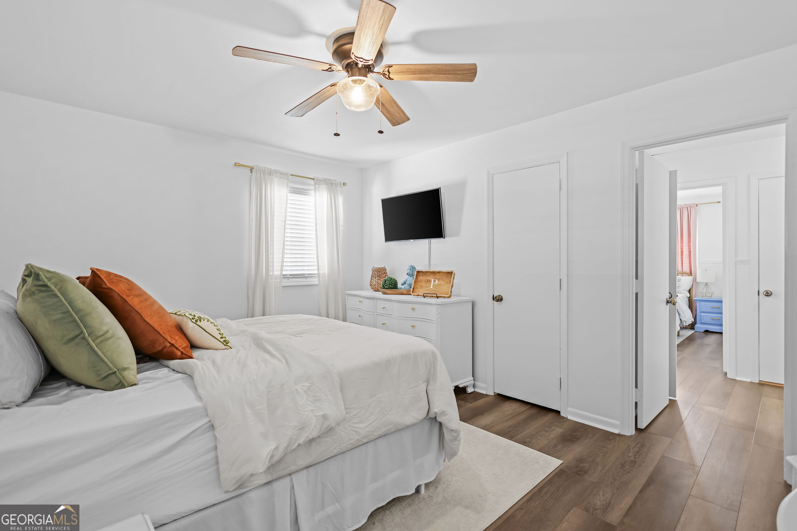 548 South 5th Street Jesup, GA 31545 - Photo 17 of 45 a bedroom with a large bed and a tv