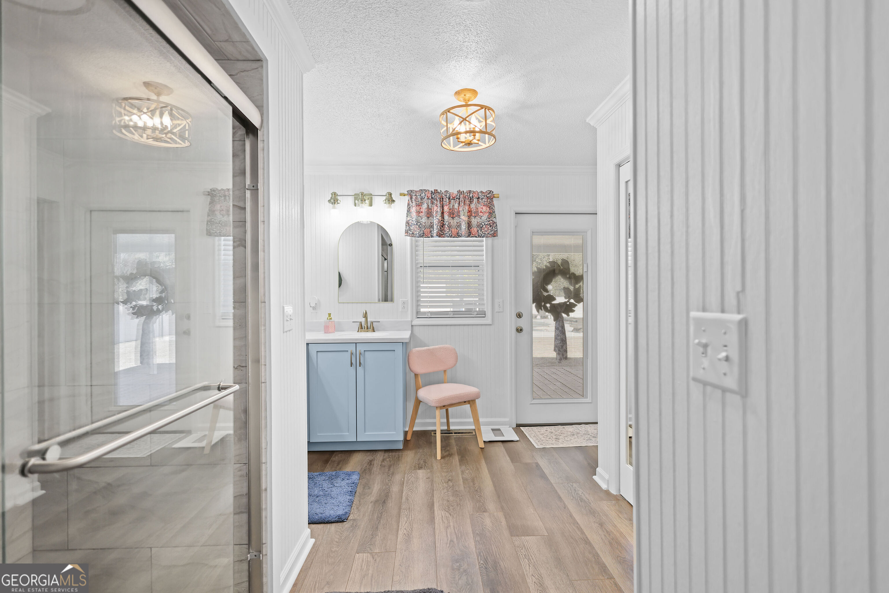 548 South 5th Street Jesup, GA 31545 - Photo 21 of 45 a workspace with wooden floor and a chandelier