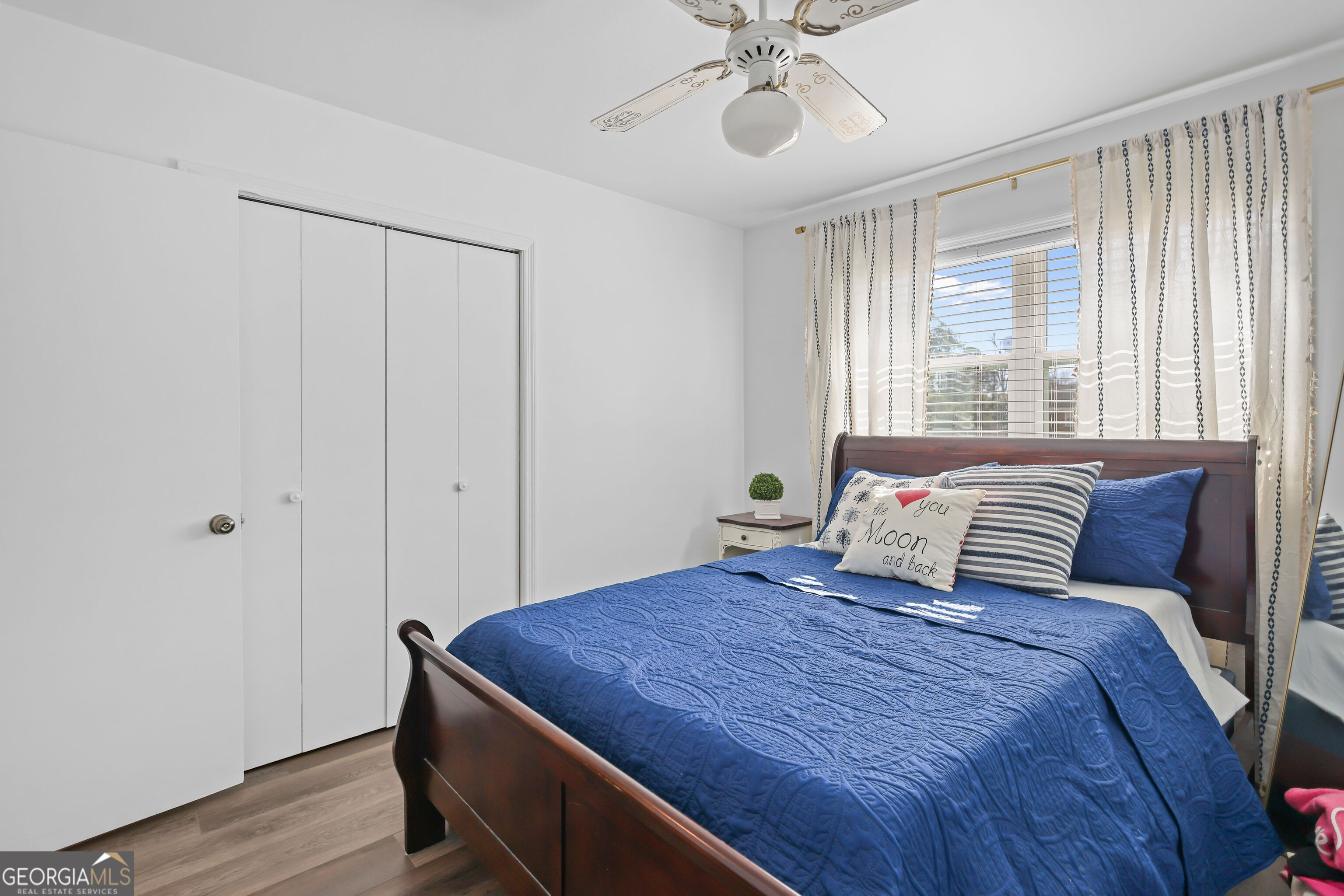 548 South 5th Street Jesup, GA 31545 - Photo 24 of 45 a bedroom with a large bed and a chandelier