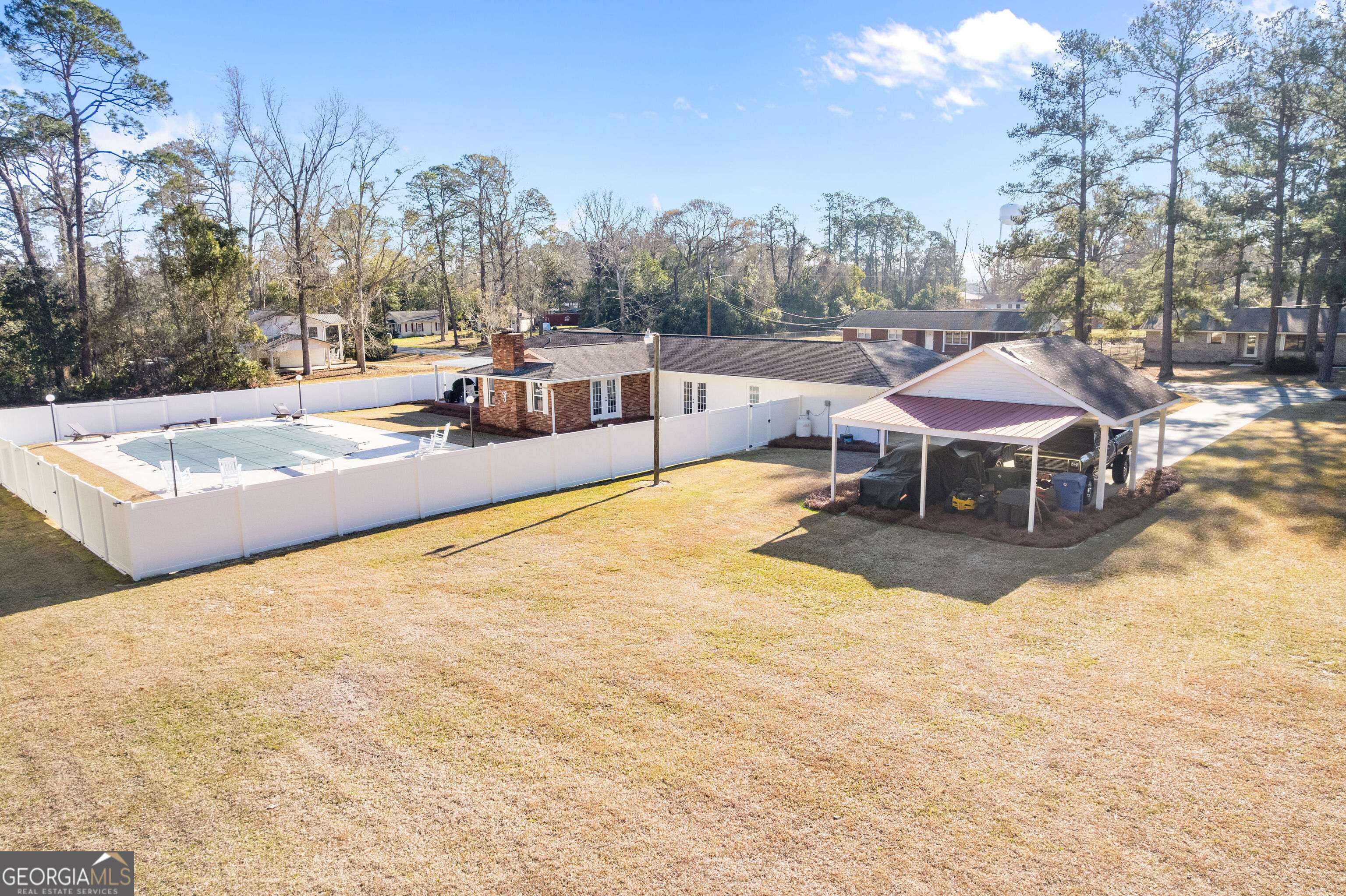 548 South 5th Street Jesup, GA 31545 - Photo 3 of 45 a view of a swimming pool with a table and chairs