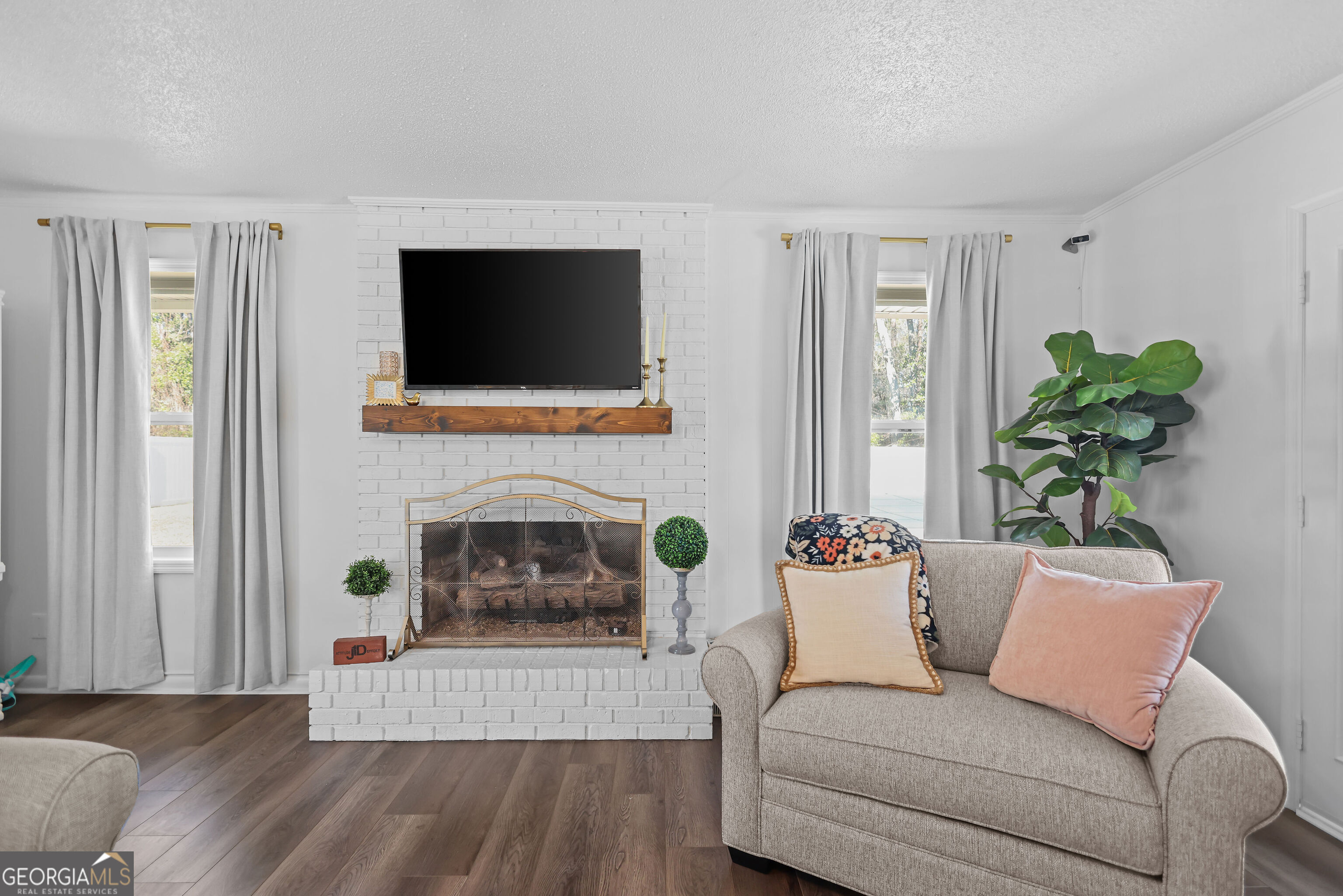 548 South 5th Street Jesup, GA 31545 - Photo 9 of 45 a living room with furniture a flat screen tv and a fireplace