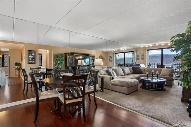 a living room with lots of furniture and a potted plant