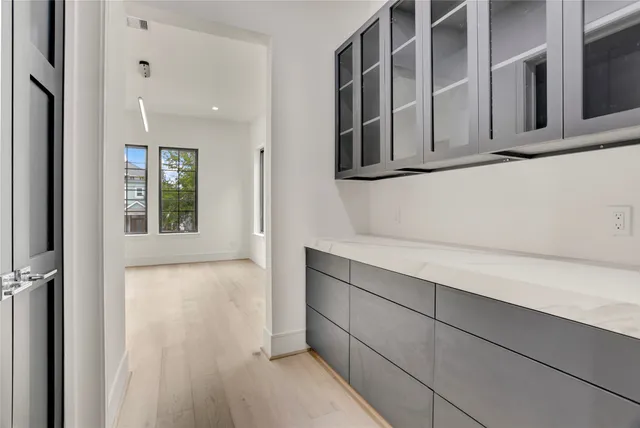 a view of an empty room with glass door and balcony
