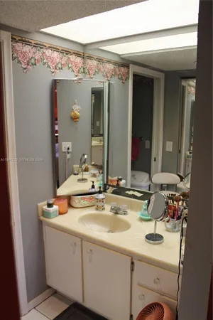 a bathroom with a sink vanity granite and a mirror
