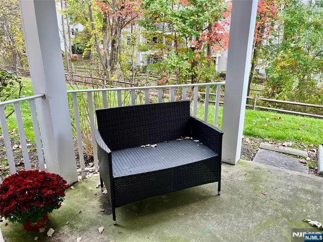 a wooden bench sitting in front of a building