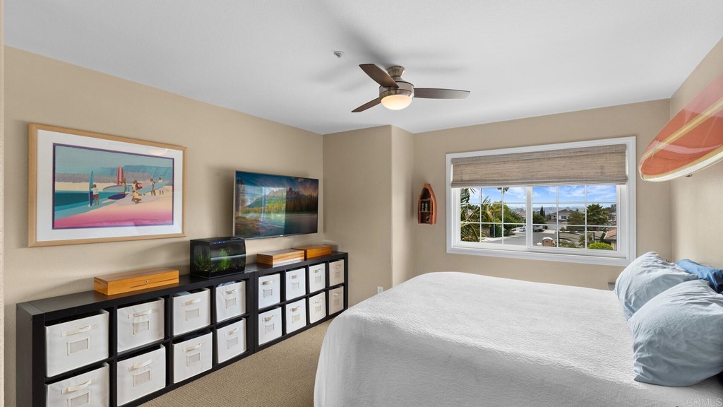 608 Crest Drive Encinitas, CA 92024 - Photo 14 of 25 a bedroom with furniture window and flat screen tv