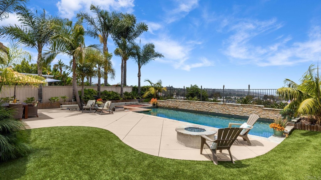 608 Crest Drive Encinitas, CA 92024 - Photo 3 of 25 a view of a swimming pool with a table and chairs