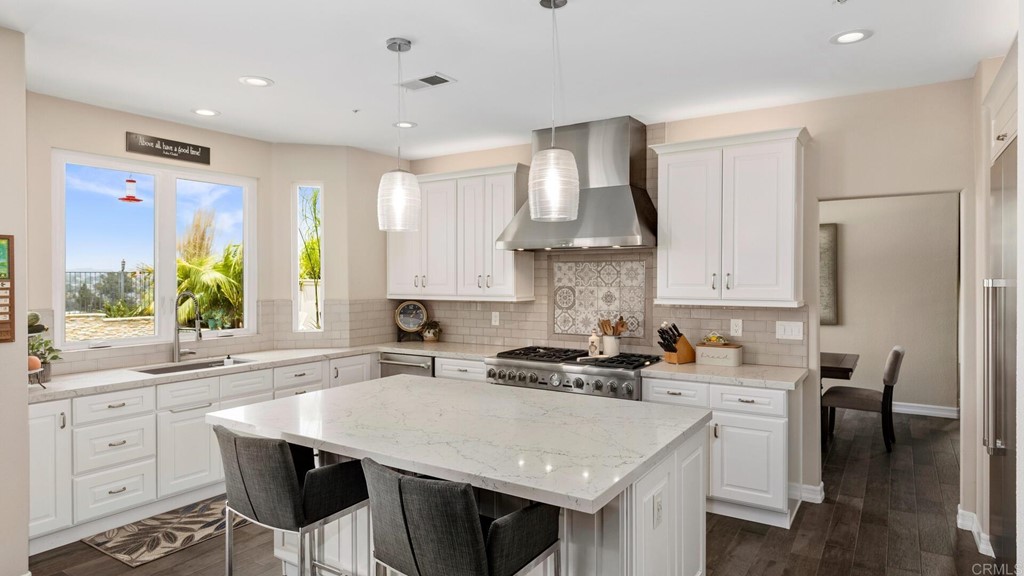 608 Crest Drive Encinitas, CA 92024 - Photo 4 of 25 a kitchen with a white cabinets and chairs