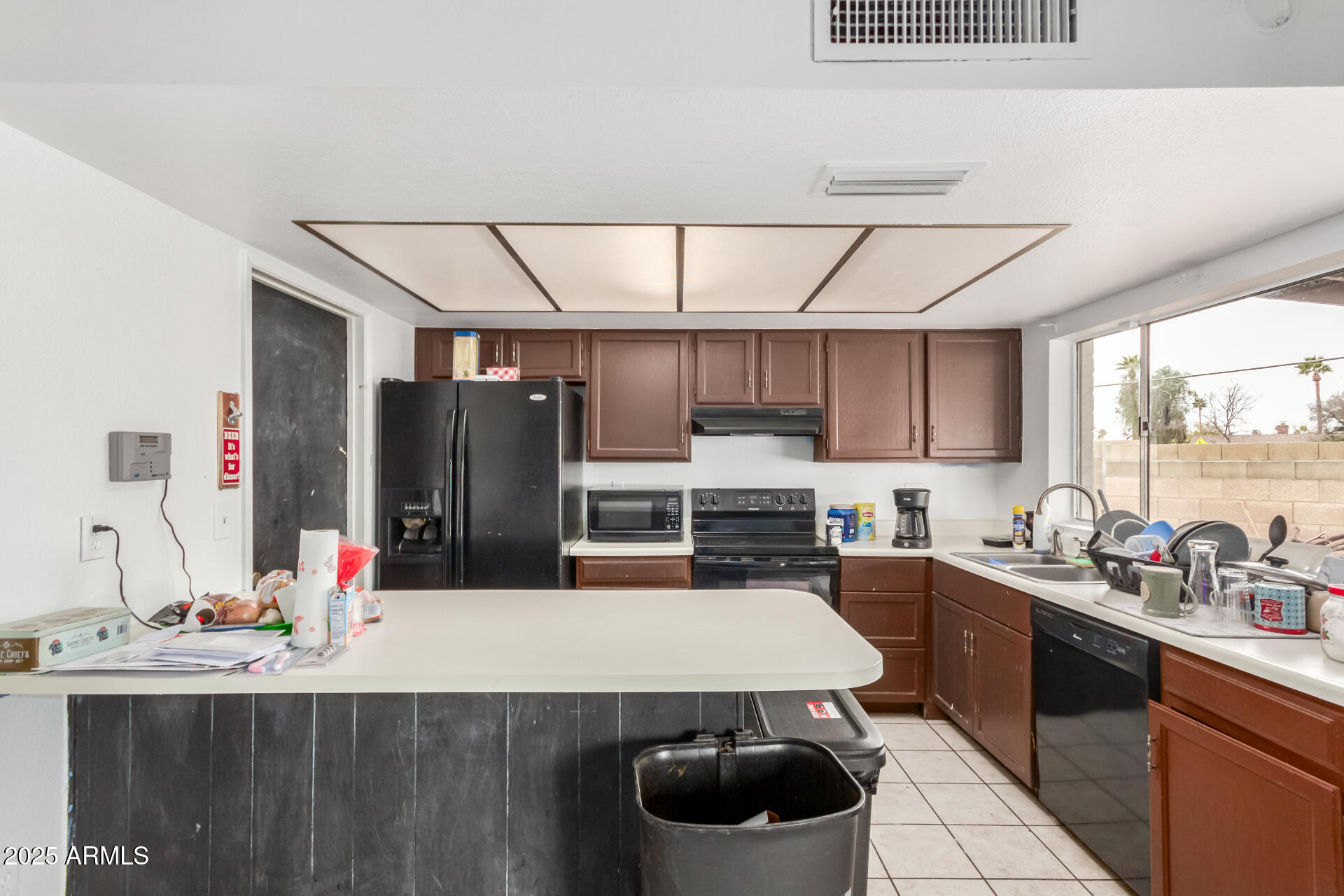 8536 North 42nd Drive Phoenix, AZ 85051 - Photo 18 of 39 a kitchen with a sink a stove and cabinets