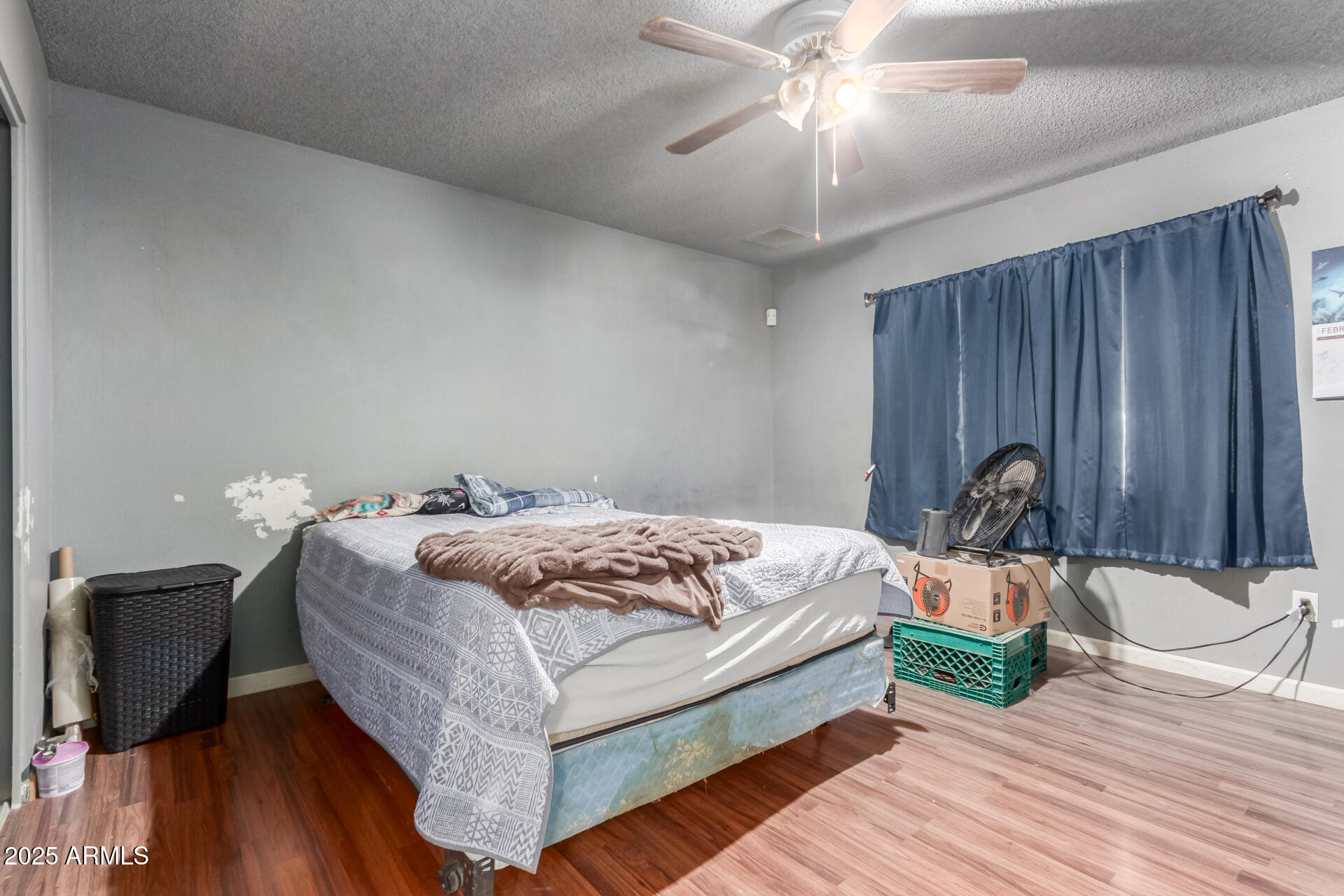 8536 North 42nd Drive Phoenix, AZ 85051 - Photo 20 of 39 a bedroom with a bed and a chandelier