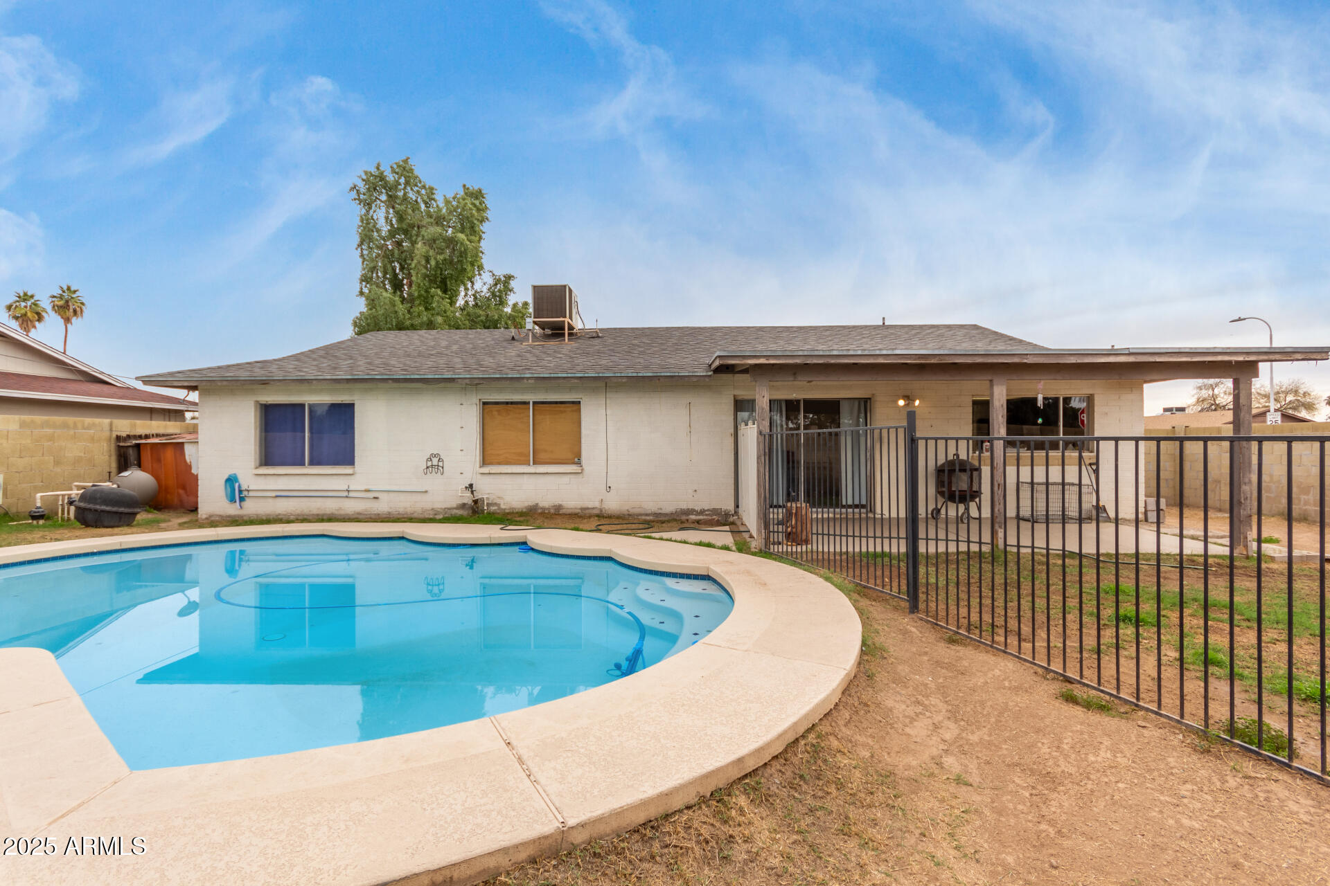 8536 North 42nd Drive Phoenix, AZ 85051 - Photo 28 of 39 a view of a house with swimming pool and porch