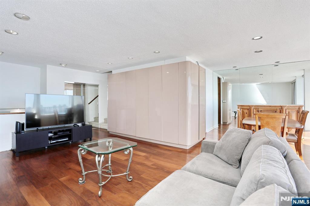 3 Horizon Road, Unit 1432 Fort Lee, NJ 07024 - Photo 11 of 49 a living room with furniture and a flat screen tv
