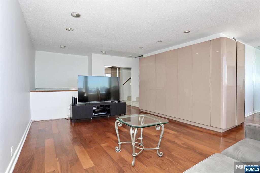 3 Horizon Road, Unit 1432 Fort Lee, NJ 07024 - Photo 12 of 49 a living room with furniture and a wooden floor