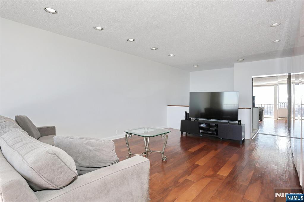 3 Horizon Road, Unit 1432 Fort Lee, NJ 07024 - Photo 13 of 49 a living room with furniture and a flat screen tv