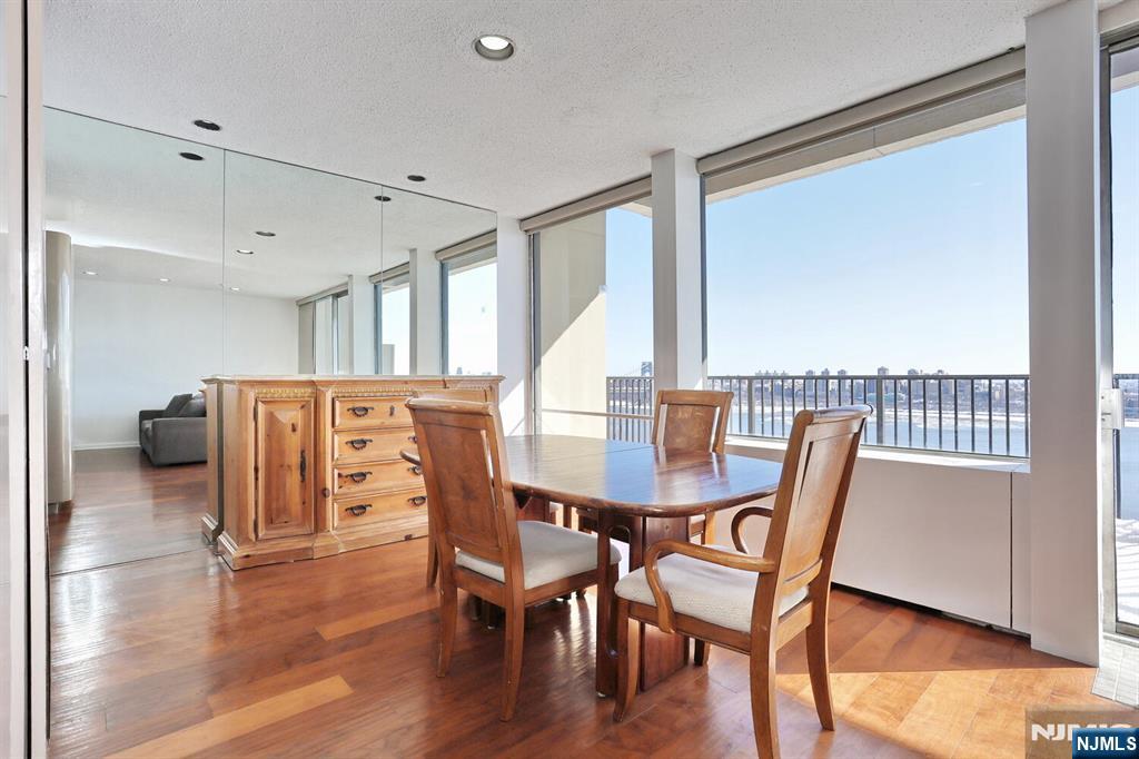 3 Horizon Road, Unit 1432 Fort Lee, NJ 07024 - Photo 15 of 49 a view of a dining room with furniture and wooden floor