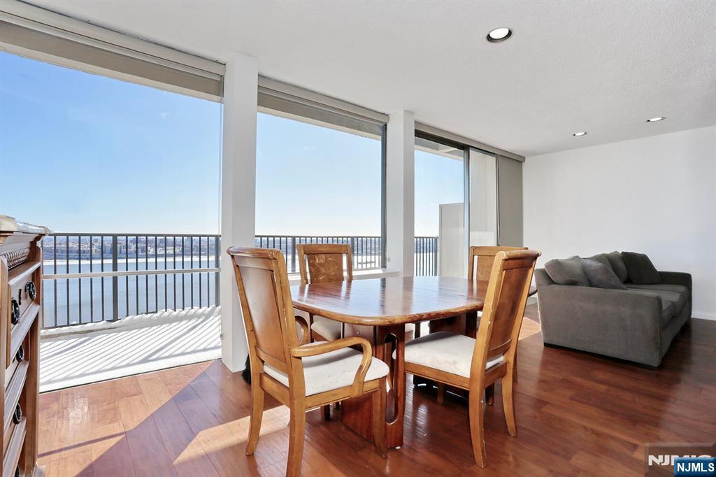3 Horizon Road, Unit 1432 Fort Lee, NJ 07024 - Photo 16 of 49 a view of a dining room with furniture and wooden floor