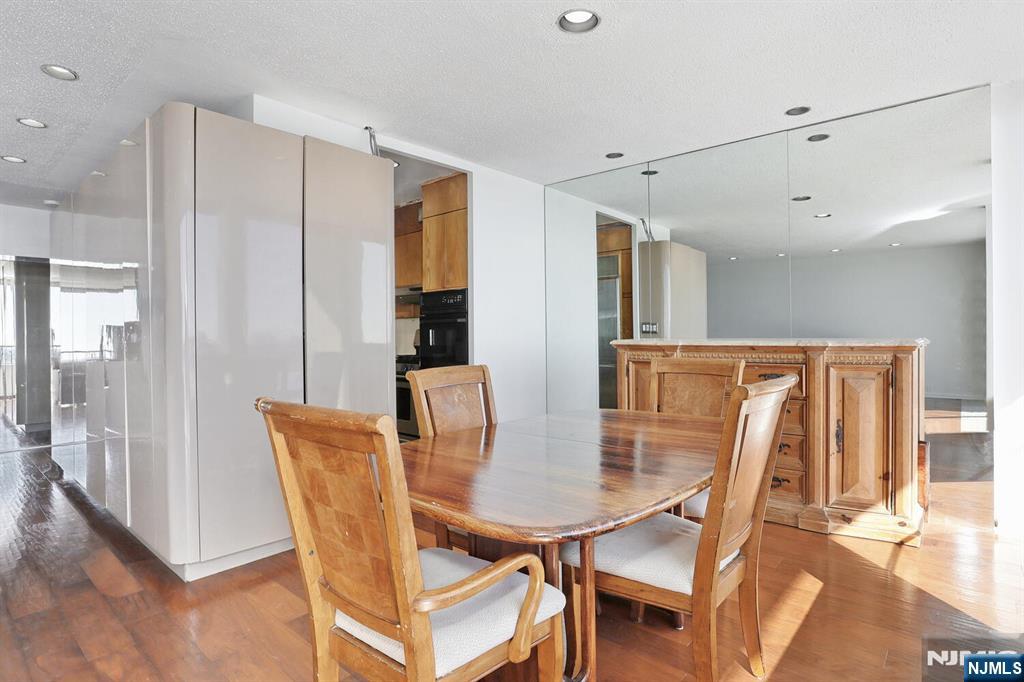 3 Horizon Road, Unit 1432 Fort Lee, NJ 07024 - Photo 23 of 49 a view of a dining room with furniture and wooden floor