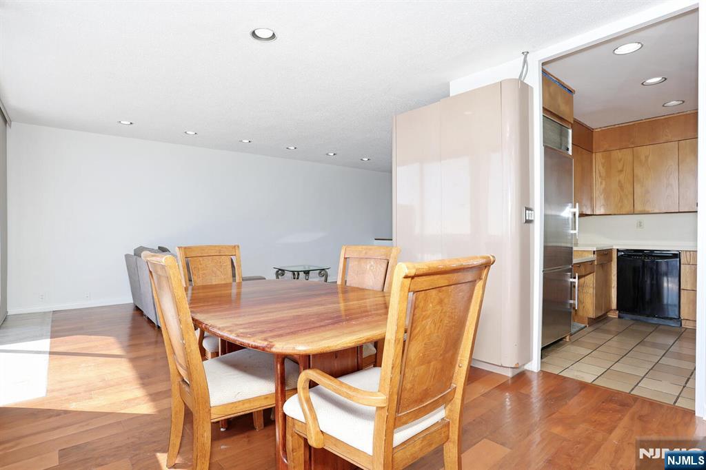 3 Horizon Road, Unit 1432 Fort Lee, NJ 07024 - Photo 24 of 49 a view of a dining room with furniture and wooden floor