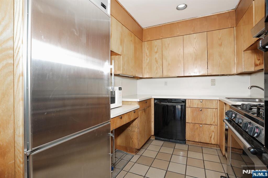 3 Horizon Road, Unit 1432 Fort Lee, NJ 07024 - Photo 25 of 49 a kitchen with a sink appliances and cabinets