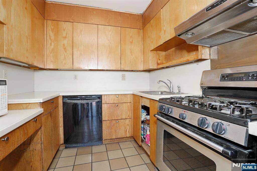 3 Horizon Road, Unit 1432 Fort Lee, NJ 07024 - Photo 26 of 49 a kitchen with stainless steel appliances granite countertop a stove and a refrigerator