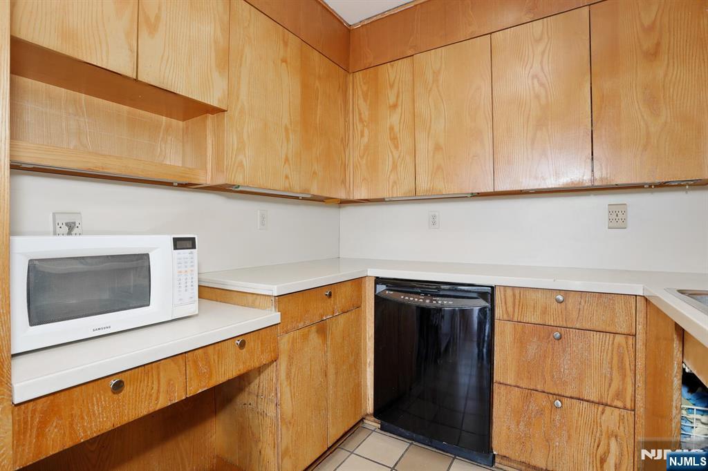 3 Horizon Road, Unit 1432 Fort Lee, NJ 07024 - Photo 27 of 49 a kitchen with stainless steel appliances a sink and cabinets