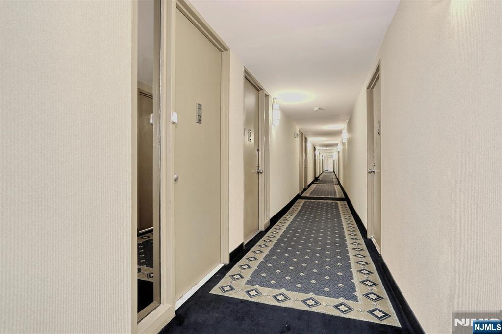 3 Horizon Road, Unit 1432 Fort Lee, NJ 07024 - Photo 3 of 49 a view of a hallway with wooden floor and staircase