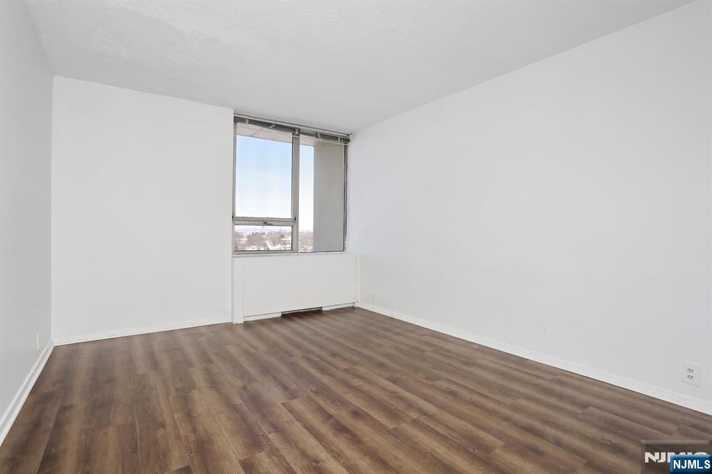 3 Horizon Road, Unit 1432 Fort Lee, NJ 07024 - Photo 37 of 49 an empty room with wooden floor and windows
