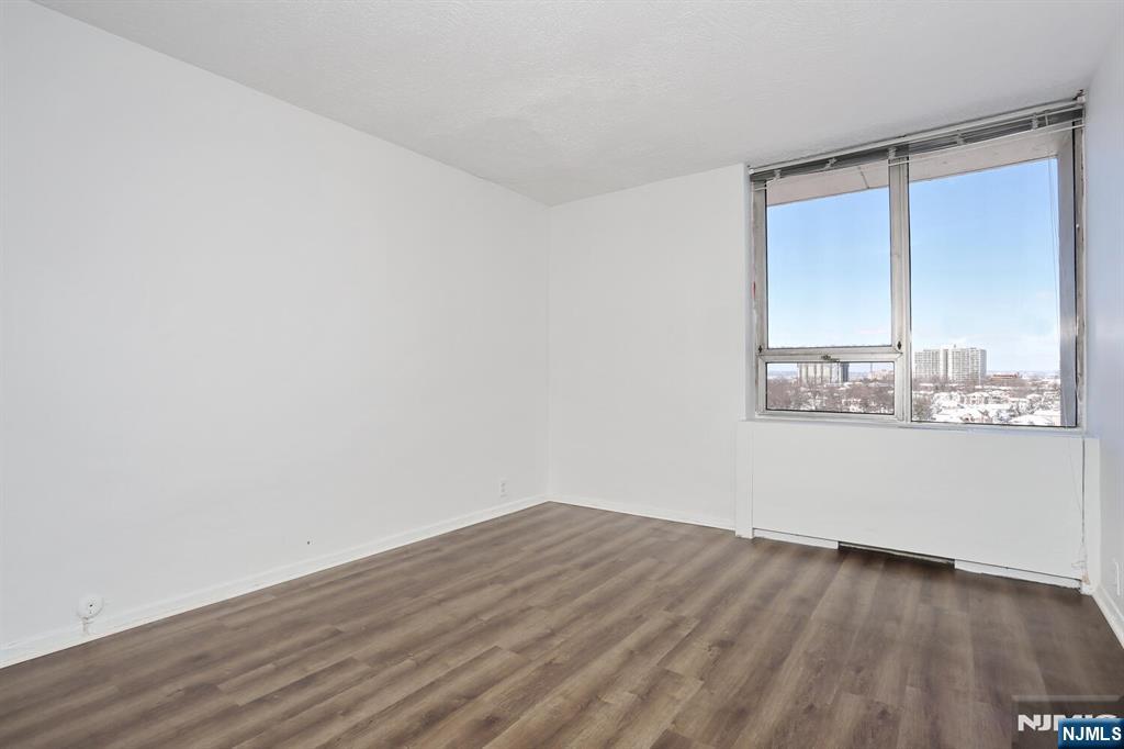3 Horizon Road, Unit 1432 Fort Lee, NJ 07024 - Photo 38 of 49 an empty room with wooden floor and windows