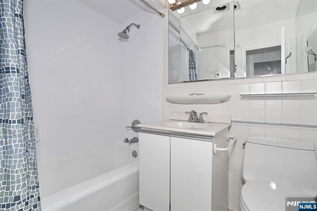 3 Horizon Road, Unit 1432 Fort Lee, NJ 07024 - Photo 40 of 49 a bathroom with a sink a toilet and shower