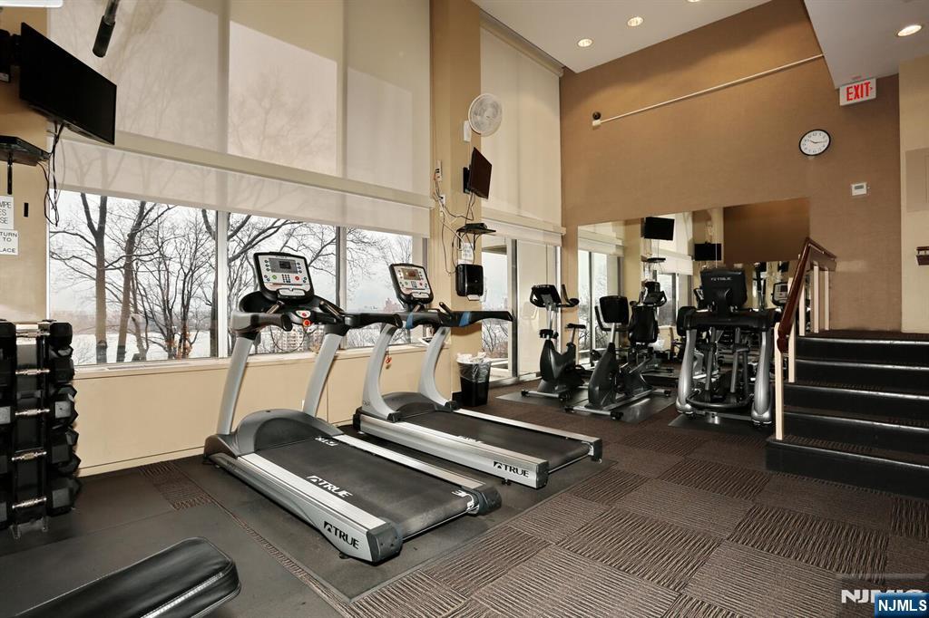 3 Horizon Road, Unit 1432 Fort Lee, NJ 07024 - Photo 43 of 49 a room with gym equipment and large mirror