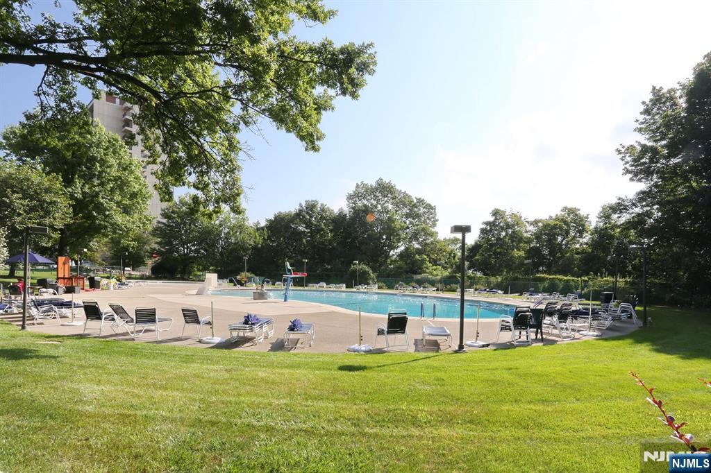 3 Horizon Road, Unit 1432 Fort Lee, NJ 07024 - Photo 44 of 49 a view of a swimming pool with a lawn chairs under an umbrella