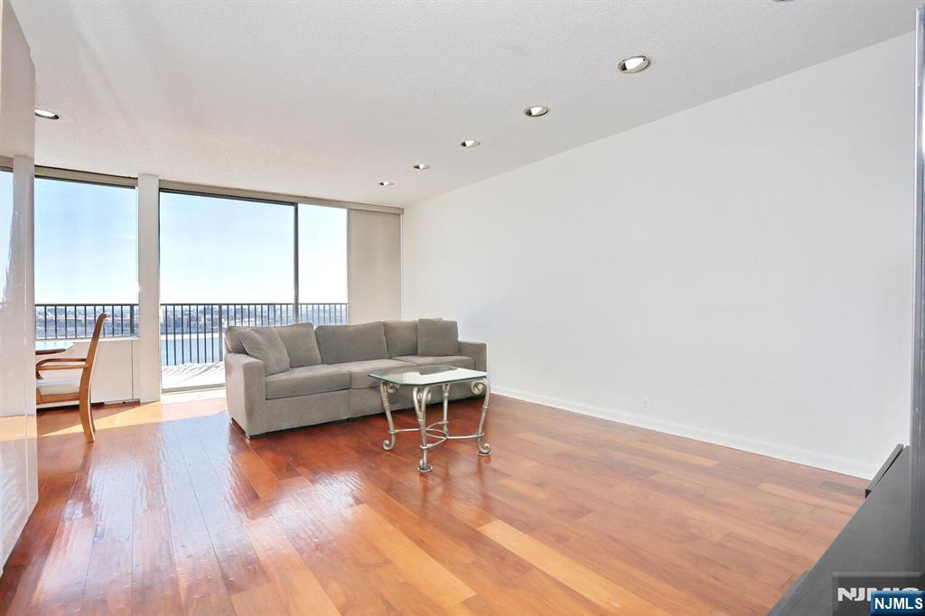 3 Horizon Road, Unit 1432 Fort Lee, NJ 07024 - Photo 7 of 49 a living room with furniture and a large window